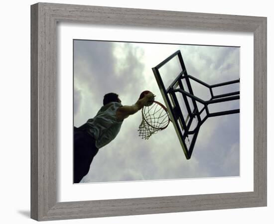 Low Angle View of a Man Shooting a Basket-null-Framed Photographic Print