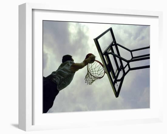 Low Angle View of a Man Shooting a Basket-null-Framed Photographic Print