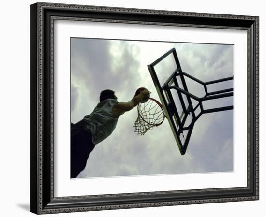 Low Angle View of a Man Shooting a Basket-null-Framed Photographic Print