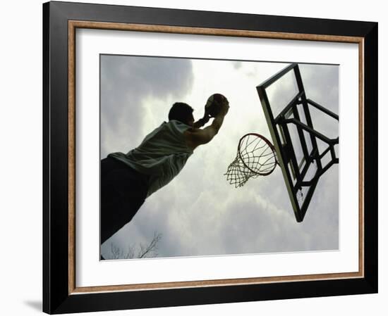 Low Angle View of a Man Shooting a Basket-null-Framed Photographic Print