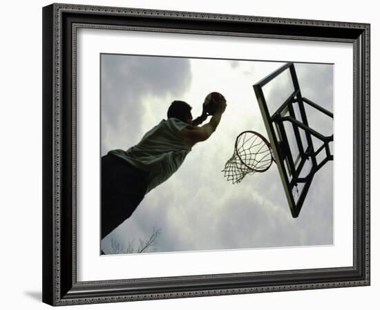 Low Angle View of a Man Shooting a Basket-null-Framed Photographic Print