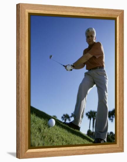 Low Angle View of a Senior Man Swinging a Golf Club-null-Framed Premier Image Canvas