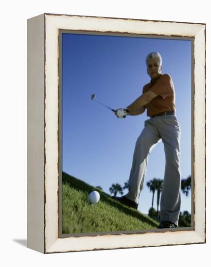 Low Angle View of a Senior Man Swinging a Golf Club-null-Framed Premier Image Canvas