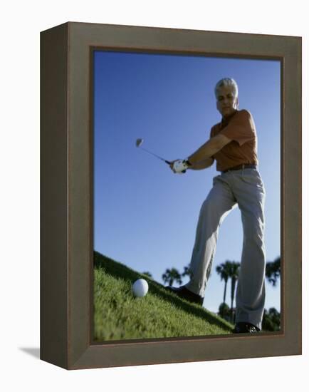 Low Angle View of a Senior Man Swinging a Golf Club-null-Framed Premier Image Canvas