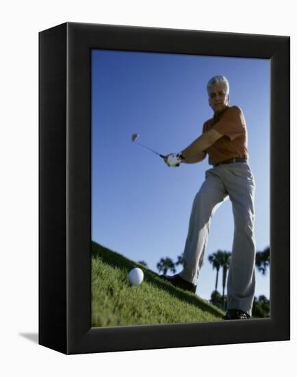 Low Angle View of a Senior Man Swinging a Golf Club-null-Framed Premier Image Canvas