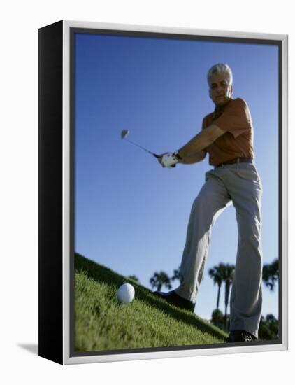 Low Angle View of a Senior Man Swinging a Golf Club-null-Framed Premier Image Canvas