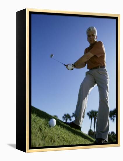 Low Angle View of a Senior Man Swinging a Golf Club-null-Framed Premier Image Canvas