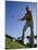 Low Angle View of a Senior Man Swinging a Golf Club-null-Mounted Photographic Print