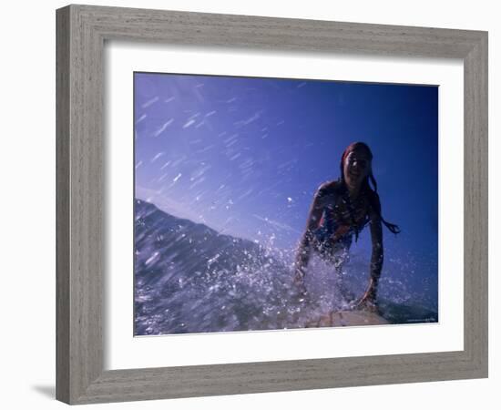 Low Angle View of a Teenage Girl Riding a Surfboard-George Silk-Framed Photographic Print