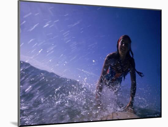 Low Angle View of a Teenage Girl Riding a Surfboard-George Silk-Mounted Photographic Print
