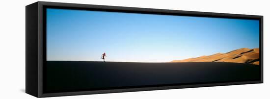 Low Angle View of a Woman Running in the Desert, Great Sand Dunes National Monument, Colorado, USA-null-Framed Premier Image Canvas