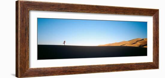 Low Angle View of a Woman Running in the Desert, Great Sand Dunes National Monument, Colorado, USA-null-Framed Photographic Print