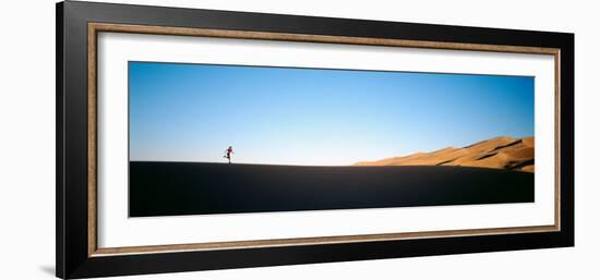 Low Angle View of a Woman Running in the Desert, Great Sand Dunes National Monument, Colorado, USA-null-Framed Photographic Print