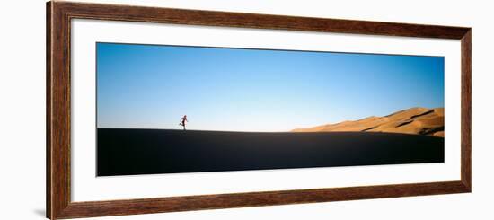 Low Angle View of a Woman Running in the Desert, Great Sand Dunes National Monument, Colorado, USA-null-Framed Photographic Print