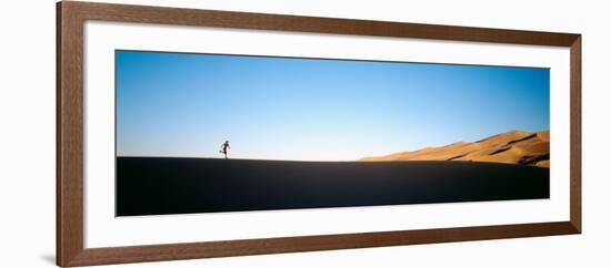 Low Angle View of a Woman Running in the Desert, Great Sand Dunes National Monument, Colorado, USA-null-Framed Photographic Print