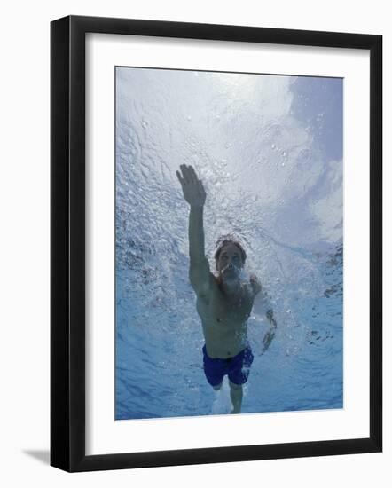 Low Angle View of a Young Man Swimming Underwater-null-Framed Photographic Print