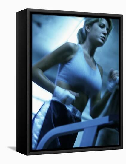 Low Angle View of a Young Woman Running on a Treadmill-null-Framed Premier Image Canvas