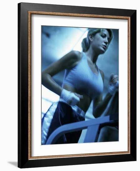 Low Angle View of a Young Woman Running on a Treadmill-null-Framed Photographic Print