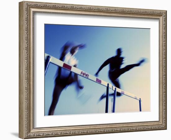 Low Angle View of Athletes Jumping over Hurdles-null-Framed Photographic Print