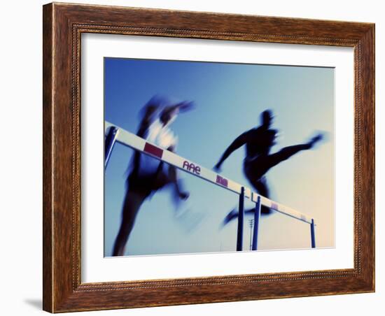 Low Angle View of Athletes Jumping over Hurdles-null-Framed Photographic Print