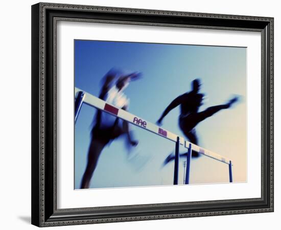 Low Angle View of Athletes Jumping over Hurdles-null-Framed Photographic Print