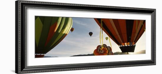 Low angle view of hot air balloons in a balloon festival, Taos Balloon Fiesta, Taos, Taos County...-null-Framed Photographic Print