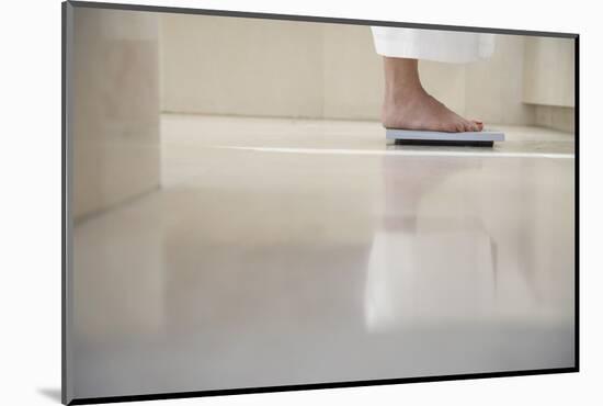 Low Section of Woman Standing on Weighing Scale in Bathroom-Nosnibor137-Mounted Photographic Print