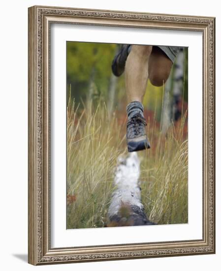 Low Section View of a Person Jumping over a Log of Wood-null-Framed Photographic Print