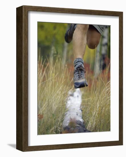 Low Section View of a Person Jumping over a Log of Wood-null-Framed Photographic Print