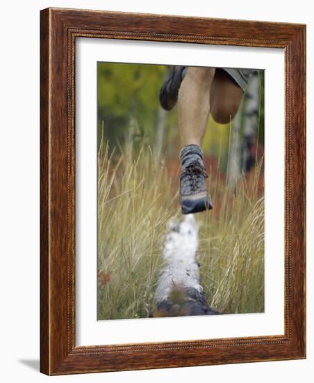 Low Section View of a Person Jumping over a Log of Wood-null-Framed Photographic Print