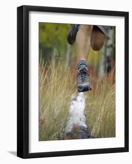 Low Section View of a Person Jumping over a Log of Wood-null-Framed Photographic Print