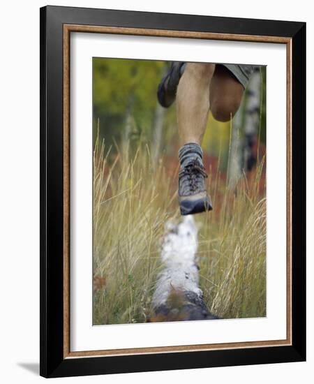 Low Section View of a Person Jumping over a Log of Wood-null-Framed Photographic Print