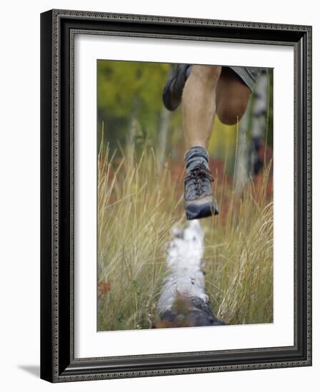 Low Section View of a Person Jumping over a Log of Wood-null-Framed Photographic Print