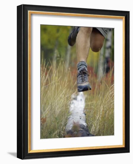 Low Section View of a Person Jumping over a Log of Wood-null-Framed Photographic Print