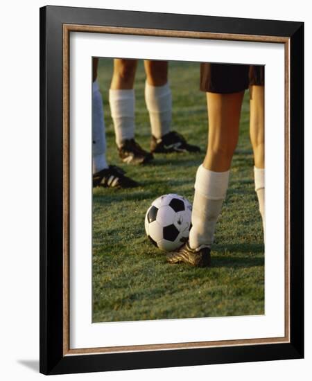 Low Section View of Soccer Players Feet and a Soccer Ball-null-Framed Photographic Print