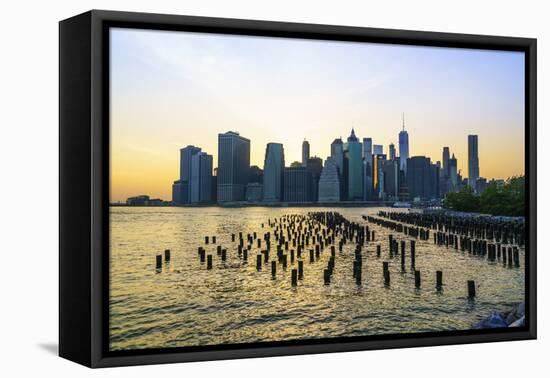 Lower Manhattan skyline across the East River at sunset, New York City, New York, United States of -Fraser Hall-Framed Premier Image Canvas