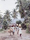 Old Haitian Woman in Front of Her Hut-Lynn Pelham-Photographic Print