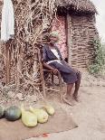 Old Haitian Woman in Front of Her Hut-Lynn Pelham-Photographic Print
