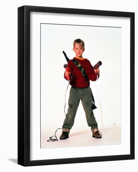 MACAULAY CULKIN. "HOME ALONE" [1990], directed by CHRIS COLUMBUS.--Framed Photographic Print