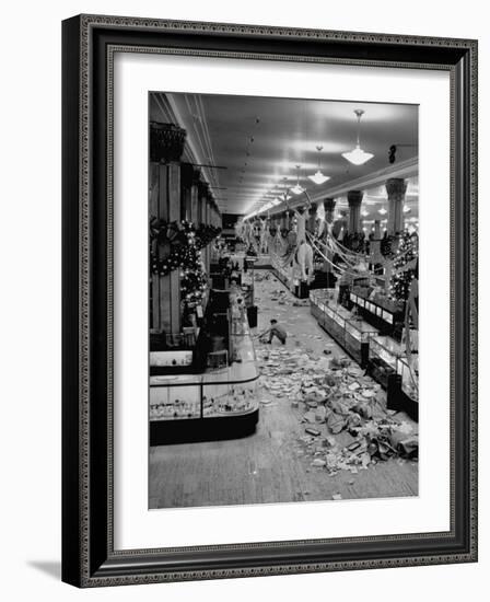 Macy's Department Store Employee Cleaning Up Piles of Debris after the Christmas Shopping Rush-Nina Leen-Framed Photographic Print