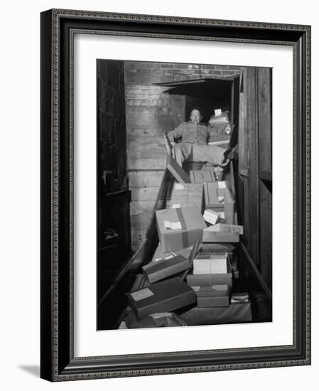 Macy's Department Store Employee Mike Reynolds Clearing the Package Chute with His Body-Nina Leen-Framed Photographic Print