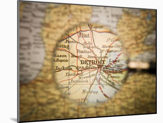 Magnifying Glass In Front Of A Detroit Map-gemenacom-Mounted Art Print