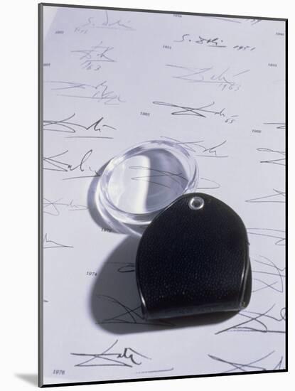 Magnifying Glass on Sheet of Real Dali Signatures-Volker Steger-Mounted Photographic Print