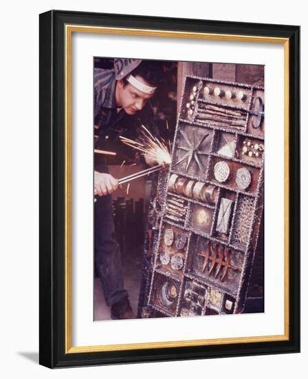 Maker of Metal Furniture, Paul Evans, Hope, PA., Burnishes Door of Steel Chest with Acetylene Torch-Nina Leen-Framed Photographic Print