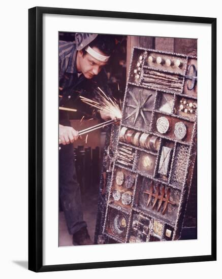 Maker of Metal Furniture, Paul Evans, Hope, PA., Burnishes Door of Steel Chest with Acetylene Torch-Nina Leen-Framed Photographic Print