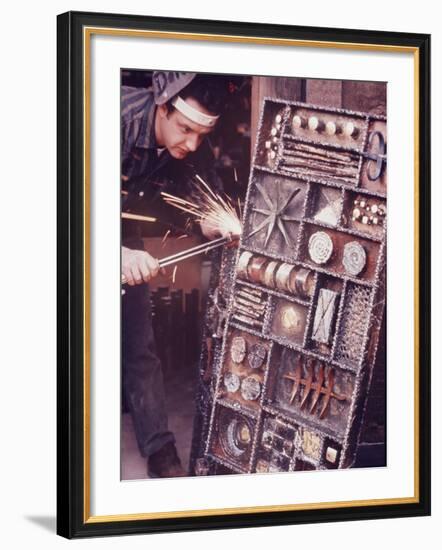 Maker of Metal Furniture, Paul Evans, Hope, PA., Burnishes Door of Steel Chest with Acetylene Torch-Nina Leen-Framed Photographic Print