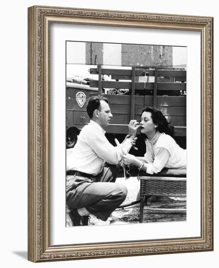 Makeup Artist Ben Nye Applying Eye Makeup to Actress Hedy Lamarr Who Observes in a Mirror-null-Framed Photo