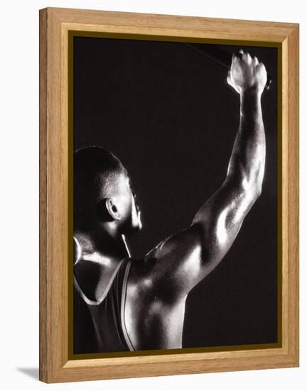 Male Runner Holding Up a Relay Baton-null-Framed Premier Image Canvas