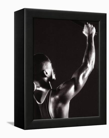 Male Runner Holding Up a Relay Baton-null-Framed Premier Image Canvas