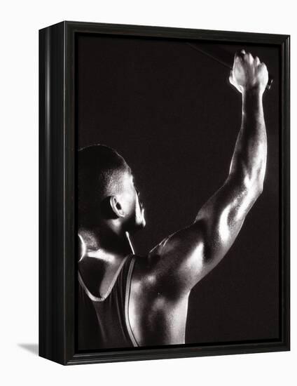 Male Runner Holding Up a Relay Baton-null-Framed Premier Image Canvas